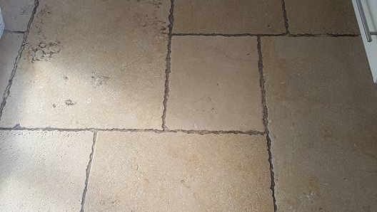 Limestone floor before restoration - scratched and heavily dulled