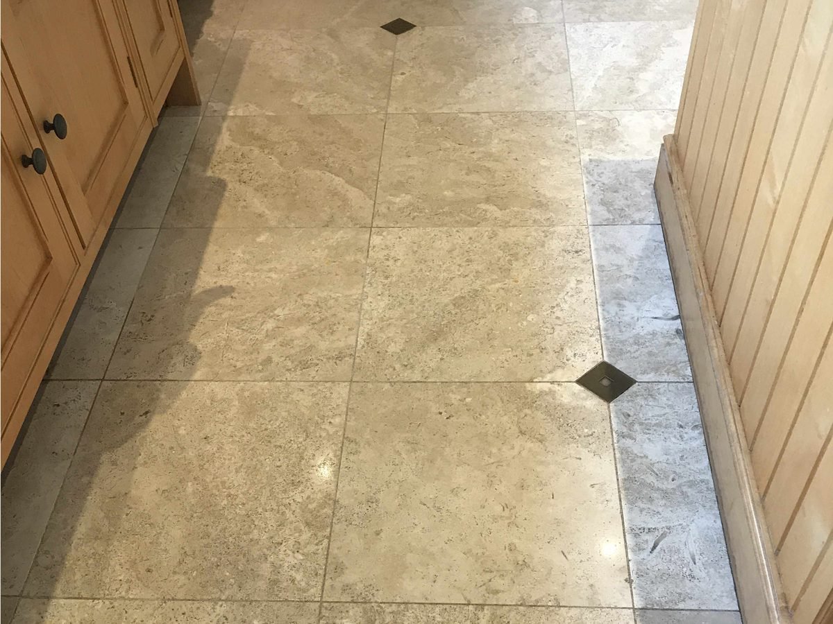 Travertine floor before stone restoration - pitted and dull surface