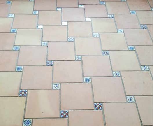 Terracotta floor before restoration - stained and heavily worn