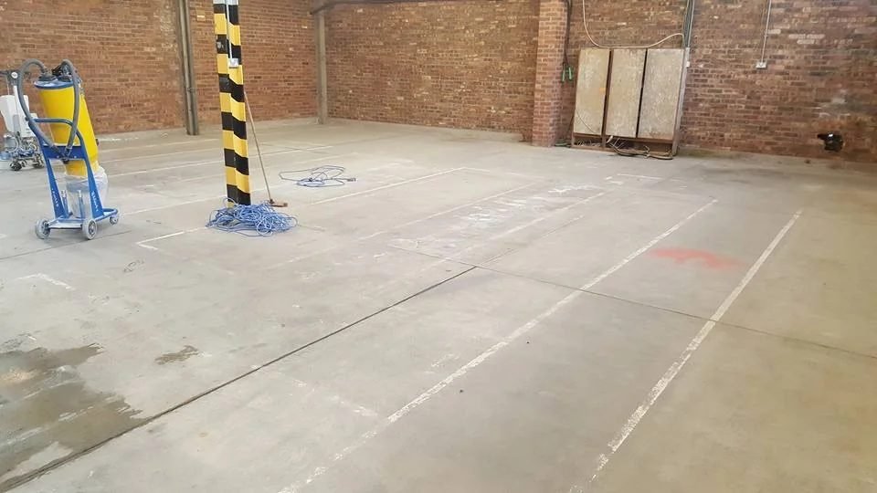 Industrial floor before concrete overlay - worn concrete surface