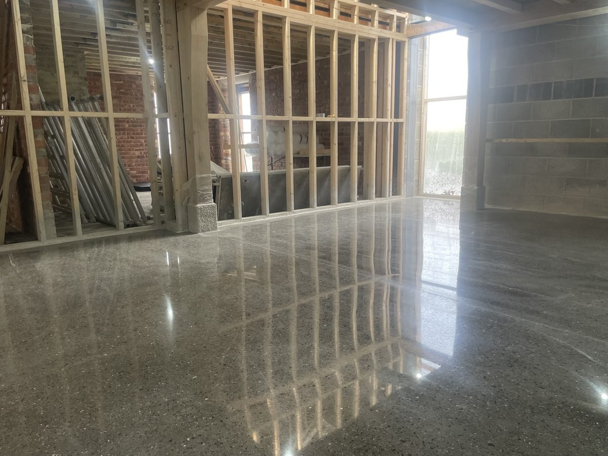 Polished concrete floor with full aggregate exposure showing stone across the surface