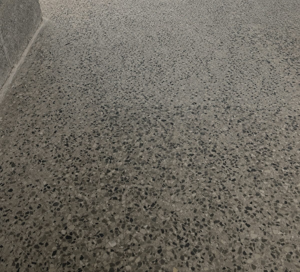 Polished concrete floor with full aggregate exposure showing stone across the surface