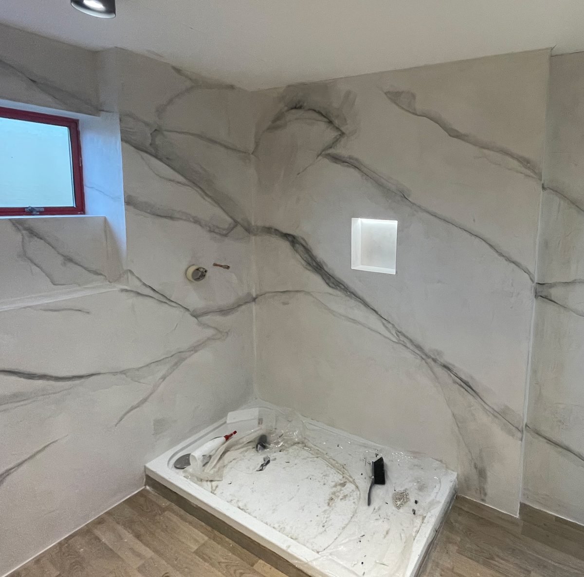 Microcement freestanding bath surround - marble effect finish